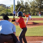 Young baseball player up to bat in official league game